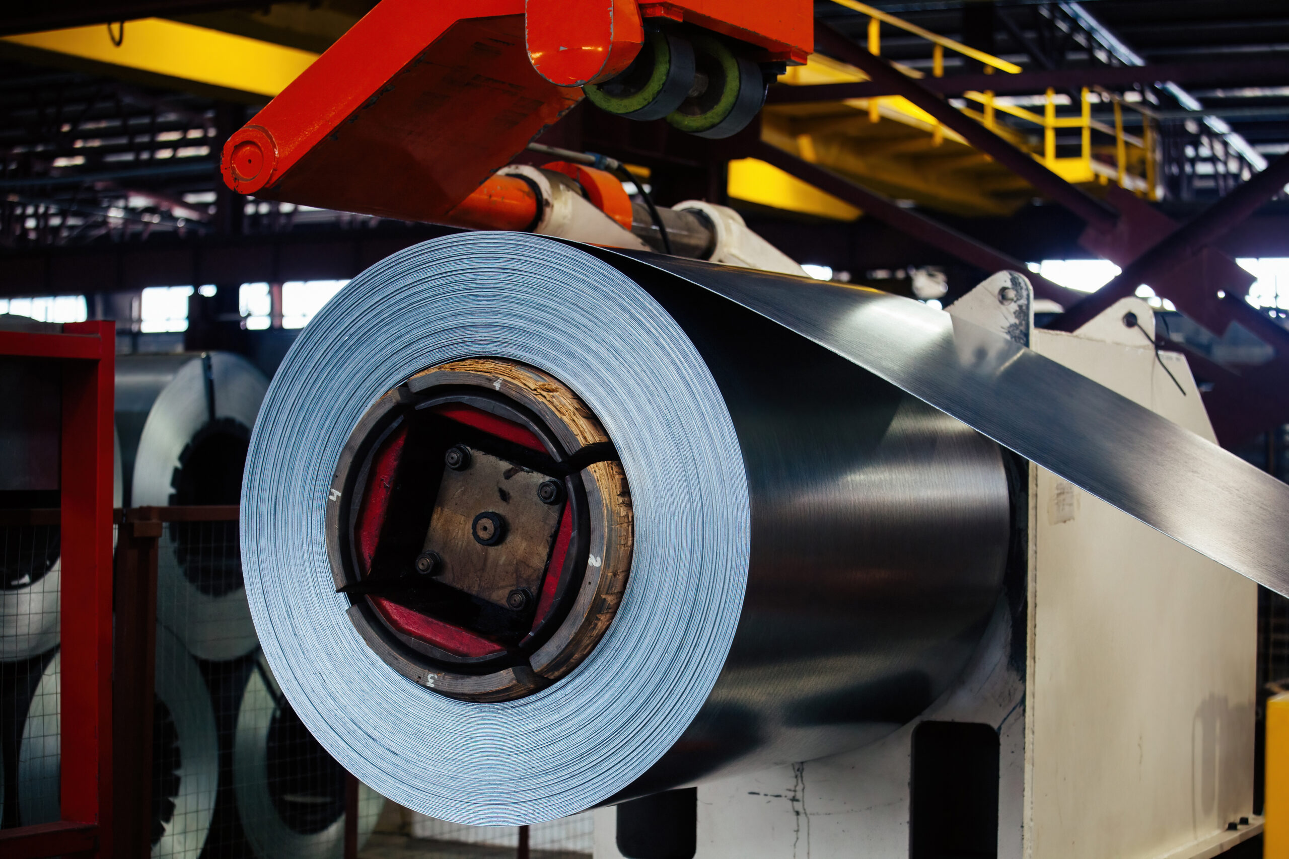 Roll of galvanized steel sheet at metalworking factory.